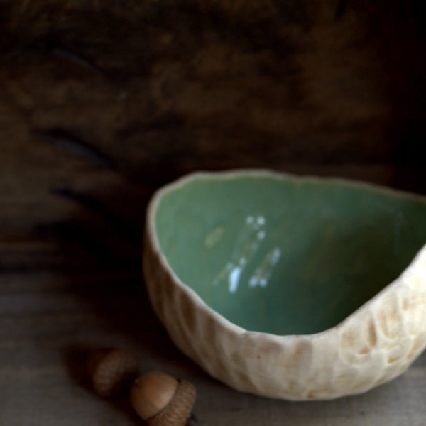 Round organic pinch pot bowl with seafoam green interior.