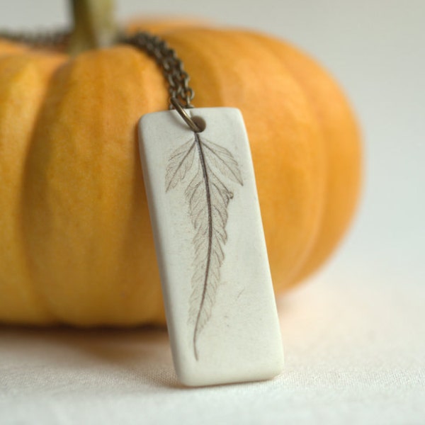 Solitary - A sweet porcelain pendant with impression of a tiny leaf.