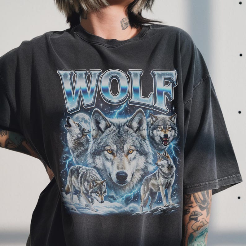 90s bootleg style collage of howling wolves with full moon, blue lightning background and silver chrome WOLF typography on dark wash fabric.