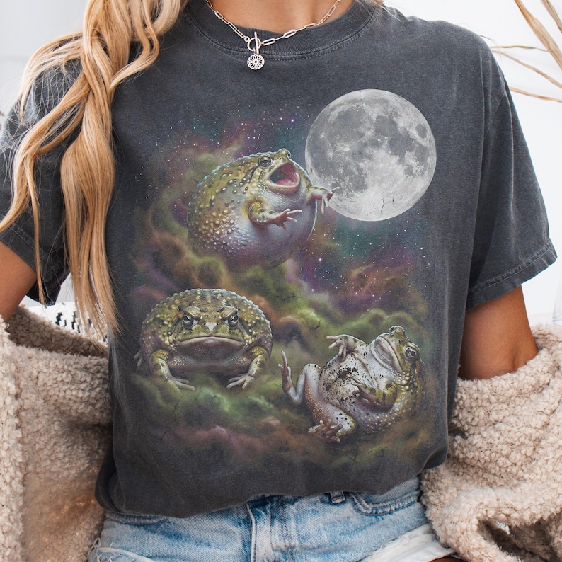 Vintage style three desert rain frogs moon graphic printed on dark washed t-shirt, cute angry rock screaming galaxy design with funny belly up pose.