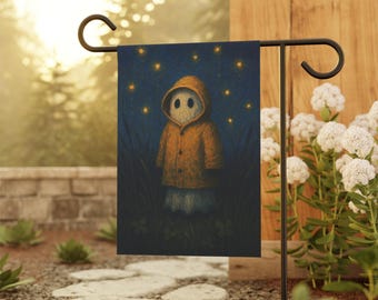 May include: A garden flag featuring a whimsical illustration of a hooded figure in an orange coat standing in tall grass under a starry night sky. The flag is displayed on a black metal garden stake, surrounded by greenery and white flowers.