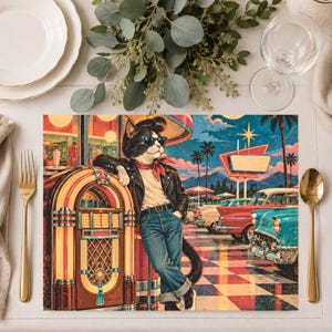 May include: A rectangular placemat featuring a stylized illustration of a cat wearing a black leather jacket, blue jeans, and sunglasses, leaning against a vintage jukebox. The background depicts a 1950s-style drive-in diner with classic cars.