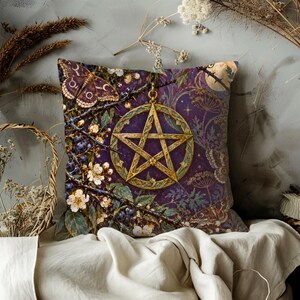 May include: A square throw pillow featuring a deep purple background with a central gold pentagram pendant. The design includes intricate illustrations of a moth, thorny branches, white blossoms, dark berries, and a pale moon in the upper corner.