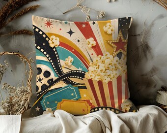 May include: A decorative throw pillow with a vintage movie theme. The pillow features a popcorn bucket, film reel, and colorful retro design with stars and a red star. The color palette includes red, yellow, blue, and black.