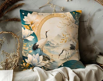 May include: Square decorative pillow with a serene Asian-inspired design. The pillow features a watercolor painting of cranes, lotus flowers, and a landscape with mountains and a pagoda. The color palette includes teal, gold, and cream.