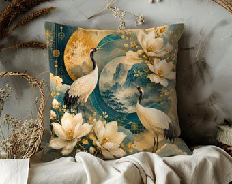 May include: Square decorative pillow featuring a serene Asian-inspired design. The pillow showcases two cranes, white flowers, and a landscape scene with mountains and a full moon. The color palette includes teal, gold, and cream tones.