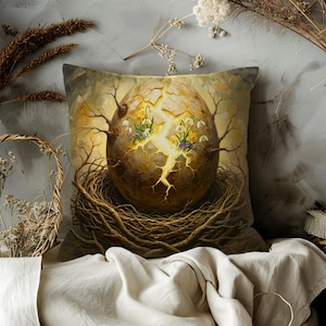 May include: Decorative square pillow featuring an artistic depiction of a cracked egg with a glowing center, nestled in a woven nest. The egg is adorned with budding branches and delicate flowers, set against a soft, neutral background.