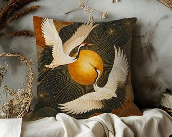May include: Decorative square pillow featuring a Japanese crane design. The pillow has a black background with a golden sun and two white cranes with red accents. The design is framed by brown and gold accents.