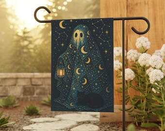 May include: A garden flag featuring a whimsical illustration of a cloaked figure holding a lantern, with a black cat at its feet. The design is set against a dark blue background with gold moons and stars, creating a celestial and spooky theme.