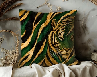 May include: Square decorative pillow featuring a tiger face and striped pattern in shades of green, black, and gold. The pillow is placed on a white surface, with dried plants and a basket in the background.