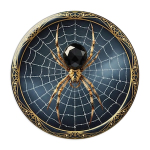 May include: A decorative plate featuring a detailed spider web design with a large black spider at the center. The plate has a dark blue background with a gold decorative border. The spider has a faceted black body and brown legs.