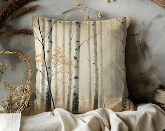 May include: Square decorative pillow featuring a serene forest scene with birch trees. The pillow has a neutral color palette with beige, gray, and touches of orange. The design evokes a sense of nature and tranquility.