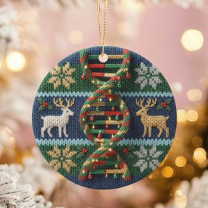 May include: Round Christmas ornament with a blue background and a DNA strand design. The ornament features a knitted pattern with snowflakes, reindeer, and a DNA strand decorated with Christmas lights. A gold string is attached for hanging.