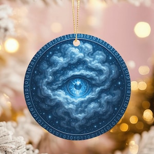 May include: Round blue Christmas ornament featuring a detailed eye design within a cloud-like pattern. The ornament has a binary code border and a gold string for hanging. The eye is a focal point, with a detailed iris and pupil.