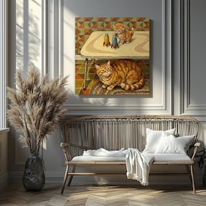 May include: A framed painting showing a ginger cat and two kittens with toy rockets. The painting features a retro table with the kittens and rockets on top. The adult cat is lying on a rug beneath the table. The background has a geometric pattern.