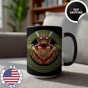 May include: Black ceramic mug featuring a steampunk Claddagh design. The design includes a heart, crown, and hands with gears, set against a green Celtic knot border. The mug has a black handle and interior.