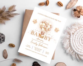 May include: A baby shower invitation with a teddy bear in a hot air balloon design. The invitation includes the text "A Little Miracle Is On The Way" and details for the event. The invitation is surrounded by decorative elements.