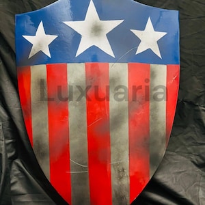 May include: A shield with a blue top section featuring three white stars and a red and silver striped bottom. The shield has the word "Luxuaria" printed on it.