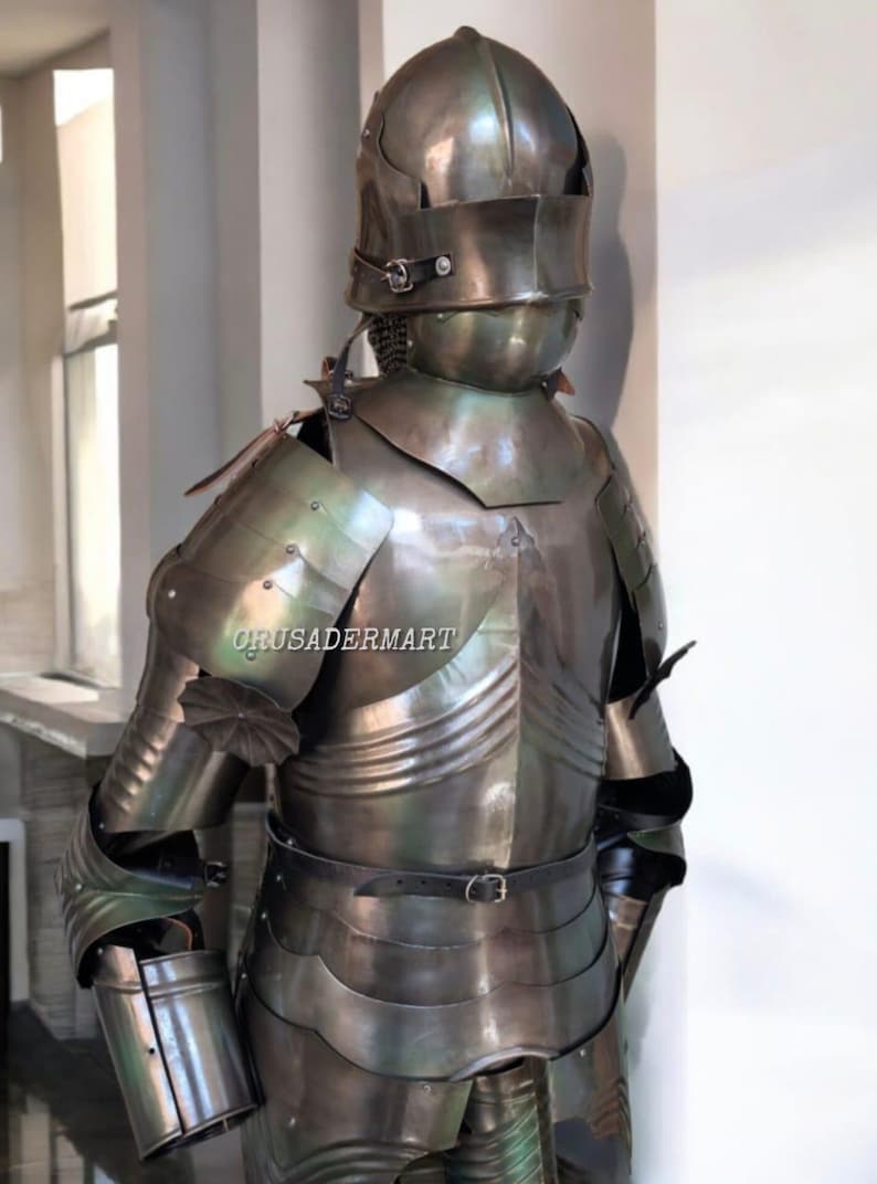 May include: A full suit of medieval armor made of polished metal. The armor includes a helmet, chest plate, shoulder guards, arm and leg protection, and a belt. The armor is designed to protect the wearer from injury in battle.