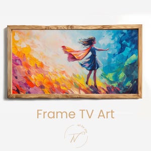 May include: A framed artwork featuring a vibrant painting of a person in a blue dress and a flowing red and orange cape. The background transitions from colorful brushstrokes to a blue sky. The frame is made of light-colored wood. Text at the bottom reads "Frame TV Art".