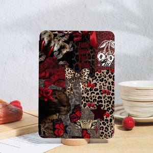 May include: A decorative tablet case featuring a collage of leopard print, red accents, and various graphics. The design includes a bow, cherries, butterflies, and the text "FUCK WHAT THEY THINK".