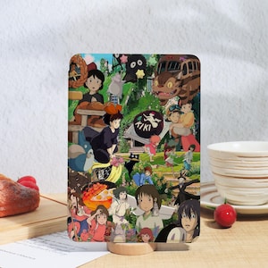 May include: A rectangular decorative panel featuring a collage of colorful anime characters and scenes. The panel includes images of characters from various animated films, with the word "KIKI" visible in a circular emblem.