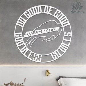 May include: White metal wall art featuring a buffalo silhouette with the text "BILLS MAFIA" and the phrases "DO GOOD BE GOOD" and "GO BILLS BLESS". The design is circular and mounted on a gray wall.