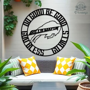 May include: Black metal wall art featuring the Buffalo Bills logo and the words "Do Good, Be Good, God Bless, Go Bills" in a circular design. The Bills Mafia text is centered within the logo. The artwork is displayed on a white wall.