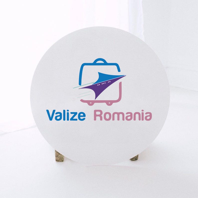 May include: A white, round sign with the text "Valize Romania" in blue and pink. The sign features a logo of a suitcase with a stylized airplane inside. The suitcase is outlined in blue, with pink wheels.