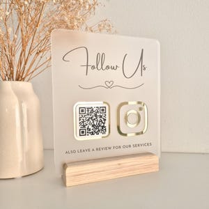 May include: A set of three ceramic mugs with a speckled, matte finish. The mugs are in shades of cream, light grey, and dark grey. Each mug has a simple, minimalist design, ideal for coffee or tea.