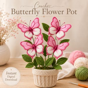 May include: A crochet butterfly flower pot featuring four pink and white butterflies with green leaves in a beige crocheted pot. The text reads Crochet Butterfly Flower Pot and Instant Digital Download. Includes yarn balls and a crochet hook.