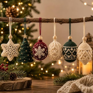 May include: Six crocheted Christmas ornaments hanging from a wooden branch. The set includes a cream star, a green tree with gold beads, a red sphere with a white snowflake, a cream textured sphere, a green sphere with white patterns, and a cream teardrop.