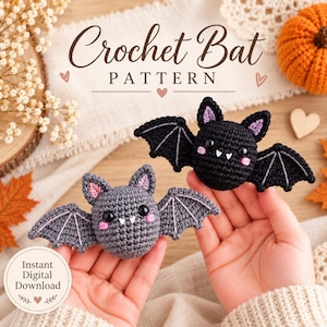 May include: Two small crocheted bats, one black and one gray, featuring black safety eyes, pink stitched cheeks, and white fangs. The text Crochet Bat PATTERN and Instant Digital Download is visible on the image, which also includes autumn decor.