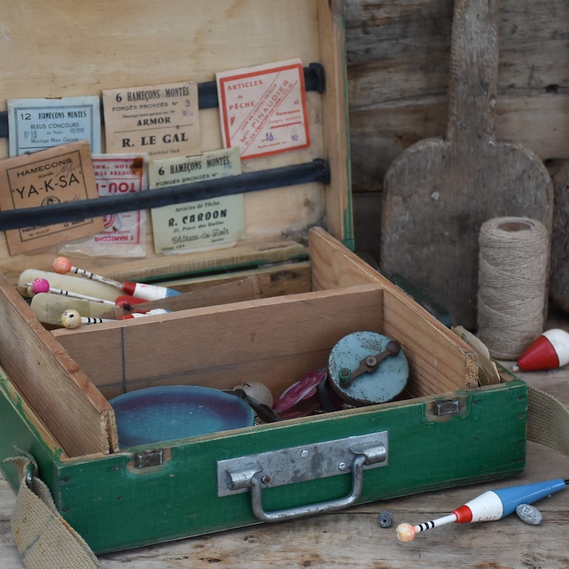 A Vintage Tackle Box Styled with Neatly Organized Hooks and Bait on a