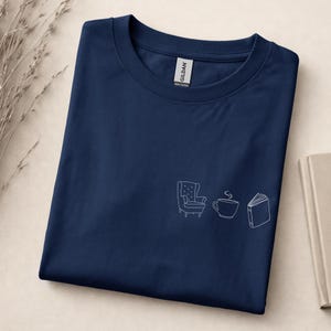 Cozy Reading Shirt – Minimalist T-shirt with armchair, tea and book, tranquil book lover look, gift for bookworms, coziness Navy