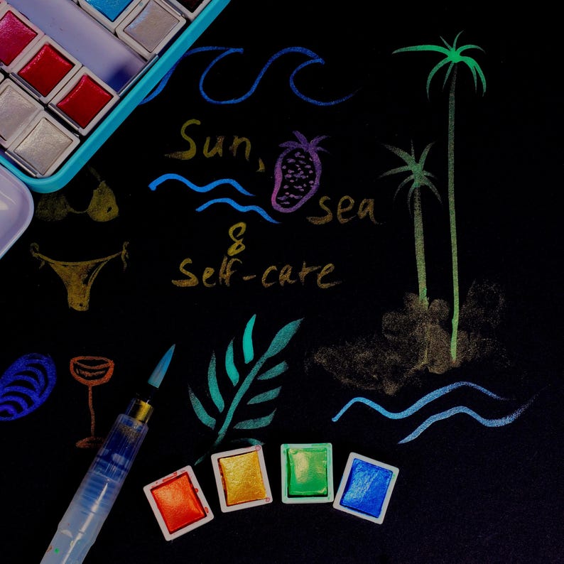 May include: A black surface with colorful watercolor paints, a brush, and drawings of a bikini, waves, palm trees, and a pineapple. Text reads "Sun, sea & Self-care."