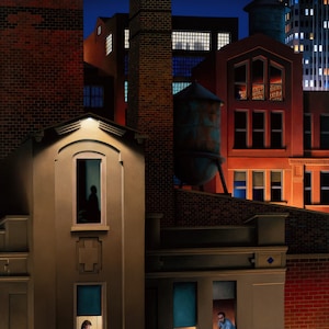 May include: A night scene of a city with multiple brick buildings. The buildings have windows with lights on inside. A person is visible in one of the windows.