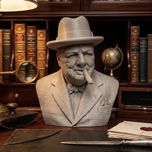 May include: A light grey bust of a man in a suit and hat, with a cigar. The bust is on a desk with books, a globe, and a magnifying glass. The background includes a wooden bookcase. The bust is a detailed sculpture.