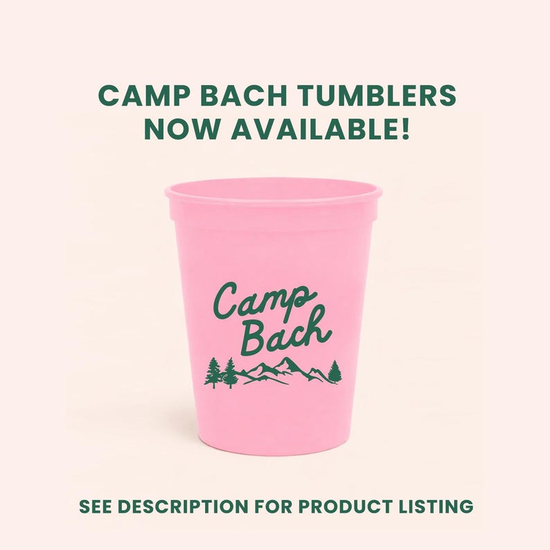 May include: A pink plastic tumbler with the words "Camp Bach" in a green script font, along with a mountain and tree graphic. The text "CAMP BACH TUMBLERS NOW AVAILABLE!" is at the top. The bottom text reads "SEE DESCRIPTION FOR PRODUCT LISTING".
