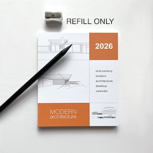 May include: A white and orange 2026 desktop calendar with modern architecture illustrations. The calendar includes the text "REFILL ONLY" and "MODERN ARCHITECTURE". A black pencil and pencil sharpener are also present.