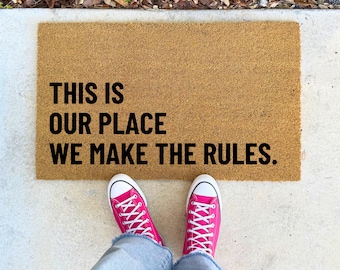 This Is Our Place We Make The Rules – 16x24" 17x30" 24x36" – Bold Quote Doormat Funny Entryway Rug for Porch House or Apartment Welcome Mat
