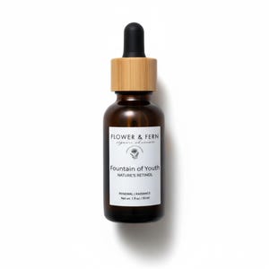 Puede incluir: Botella de vidrio marr&oacute;n con cuentagotas, etiquetada como "Flower & Fern" y "Fountain of Youth Nature's Retinol". La etiqueta tambi&eacute;n indica "Renewal | Radiance" y "Net wt. 30 ml."