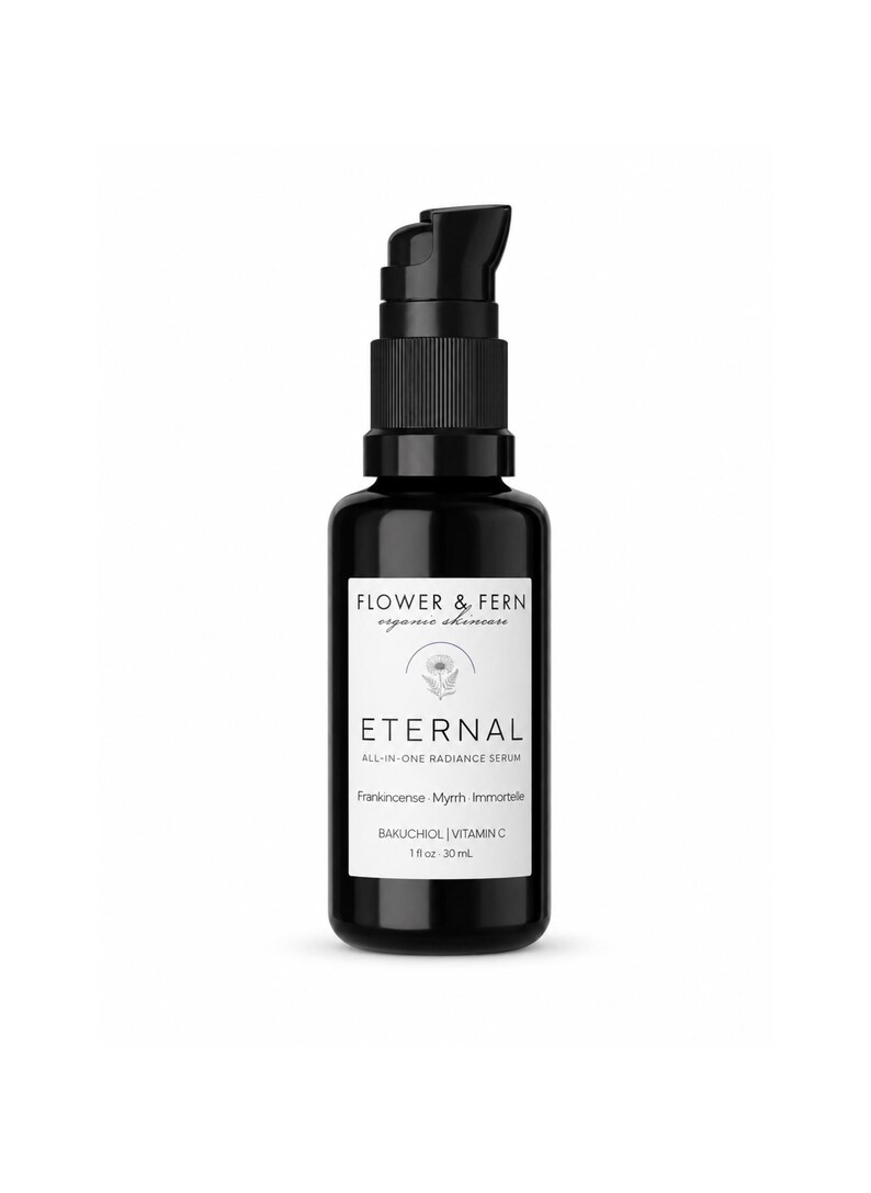 May include: A black glass bottle with a black pump dispenser containing Eternal All-In-One Radiance Serum by Flower & Fern. The white label features a floral icon, the text Bakuchiol, Vitamin C, Frankincense, Myrrh, Immortele, and 1 fl oz 30 mL.