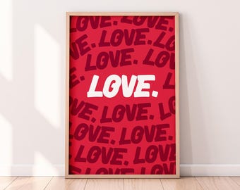 May include: A framed print with a red background and the word "LOVE" repeated in a stylized font. The word "LOVE" is written in white in the center of the print.