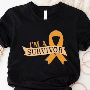 May include: Black t-shirt with the text "I'M A SURVIVOR" and an orange ribbon graphic. The shirt is knotted at the bottom. The words "CUSTOM Trendy SHIRTS" are at the bottom left.