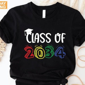 May include: Black t-shirt with the text "Class of 2034" in white, with the numbers in red, yellow, green, and blue. A graduation cap graphic is above the text. The shirt is from Custom Trendy Shirts.