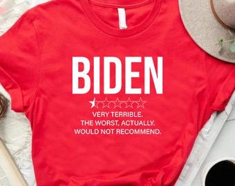 May include: A red t-shirt with the word "BIDEN" in large white letters. Below the word are four stars and the text "VERY TERRIBLE. THE WORST, ACTUALLY. WOULD NOT RECOMMEND."