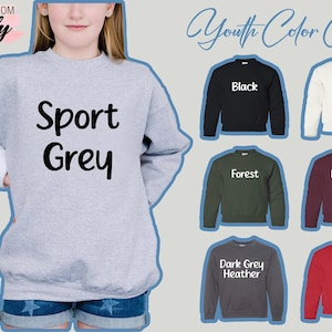 May include: A light gray sweatshirt with the words "Sport Grey" in black. The image also displays a youth color chart with sweatshirts in black, white, forest green, maroon, dark gray heather, and red.