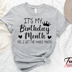 May include: Grey t-shirt with black text that reads "It's my Birthday Month. Yes, I get the whole month."  A crown graphic is above the text.