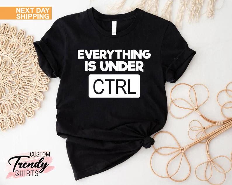 K&ouml;nnte beinhalten: Schwarzes T-Shirt mit dem wei&szlig;en Text "EVERYTHING IS UNDER CTRL". Das Shirt hat kurze &Auml;rmel und ist an der Taille geknotet. Die Worte "Custom Trendy Shirts" sind unten links aufgedruckt.